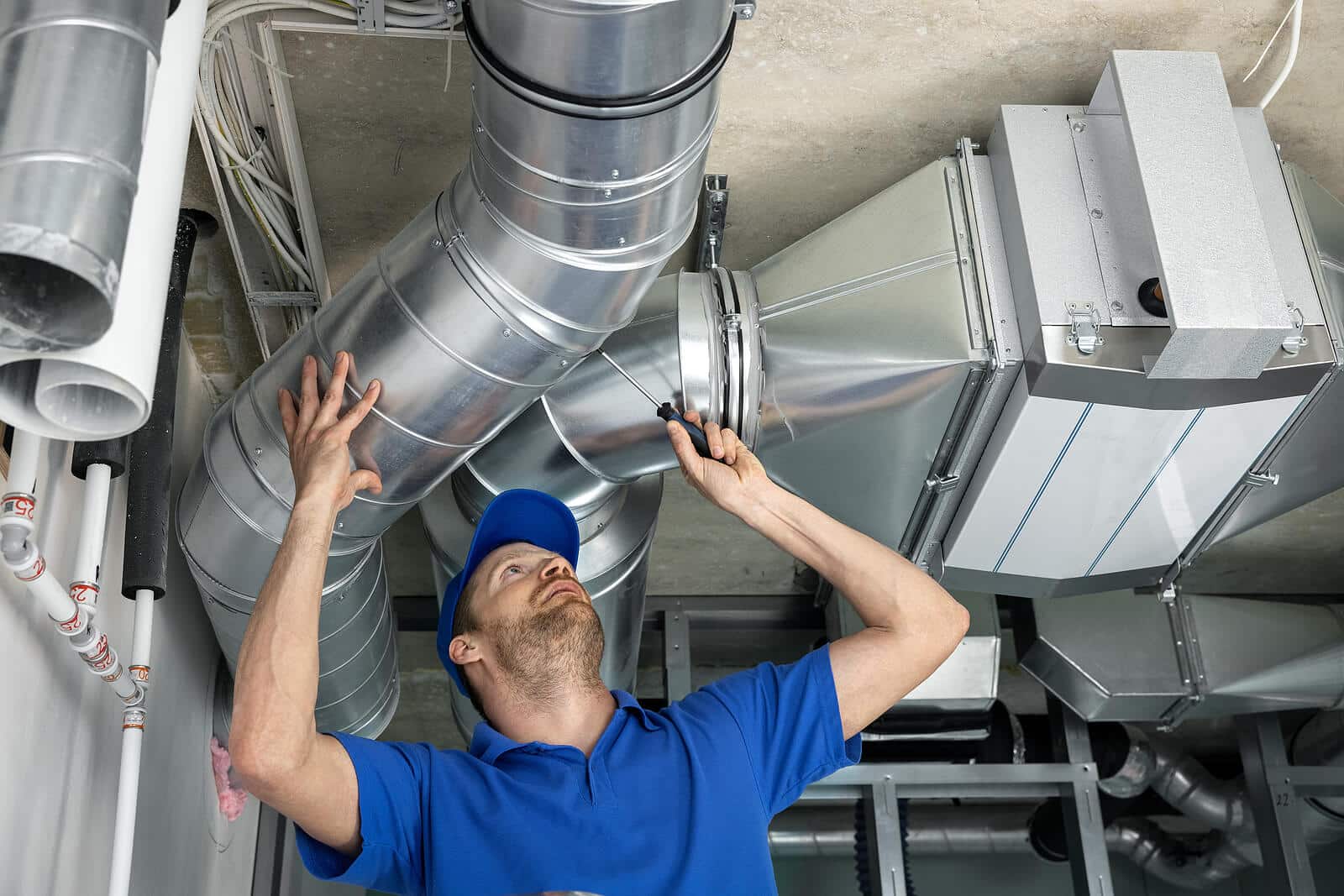 HVAC technician inspecting and repairing air ducts in Moorpark