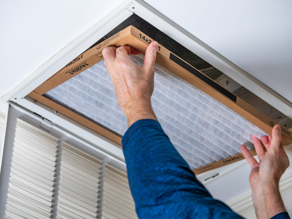 HVAC technician replacing a home air filter in Moorpark