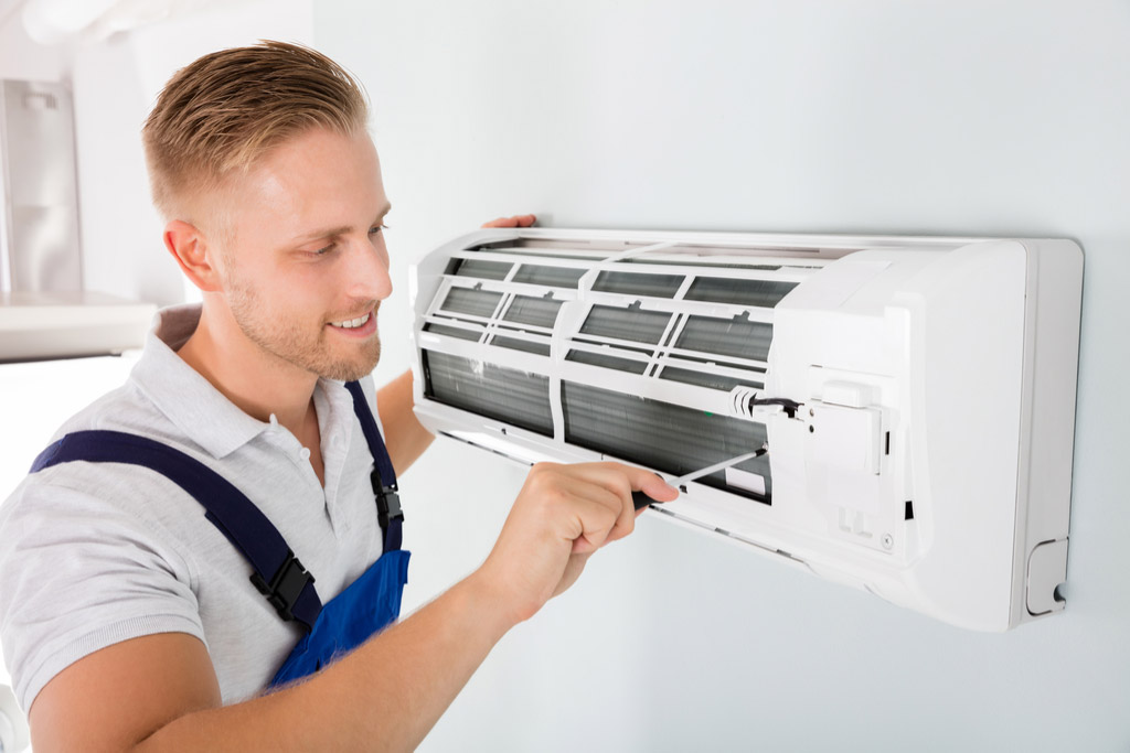HVAC technician maintaining a ductless air conditioner in Moorpark