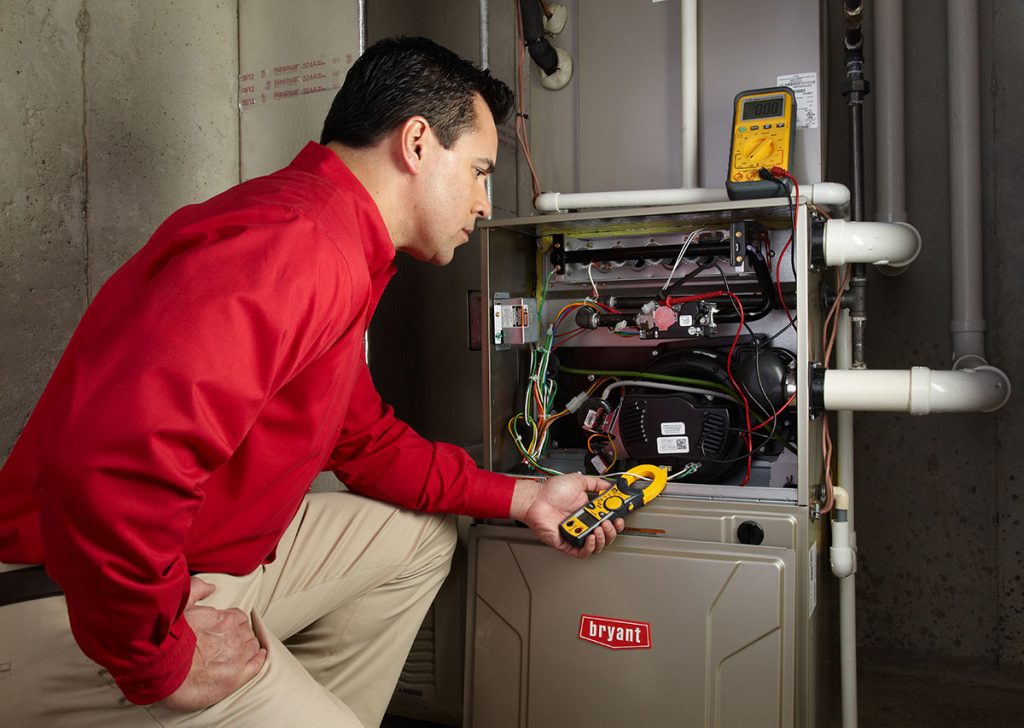 Heating technician diagnosing a furnace repair in Moorpark
