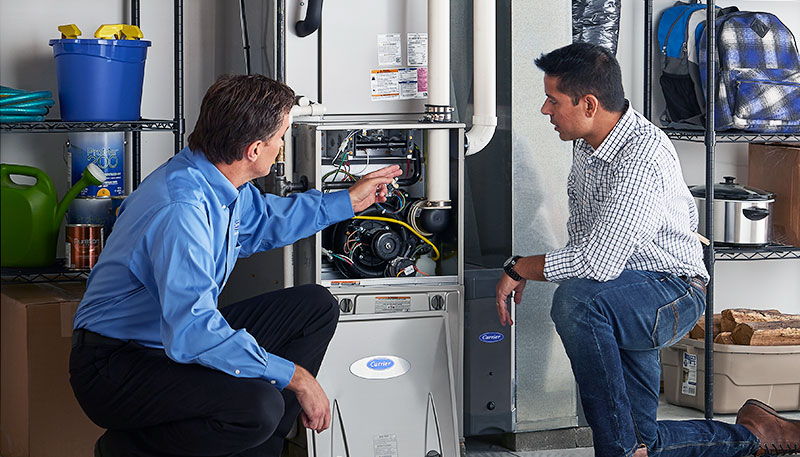 Technician evaluating a furnace for repair or replacement in Moorpark