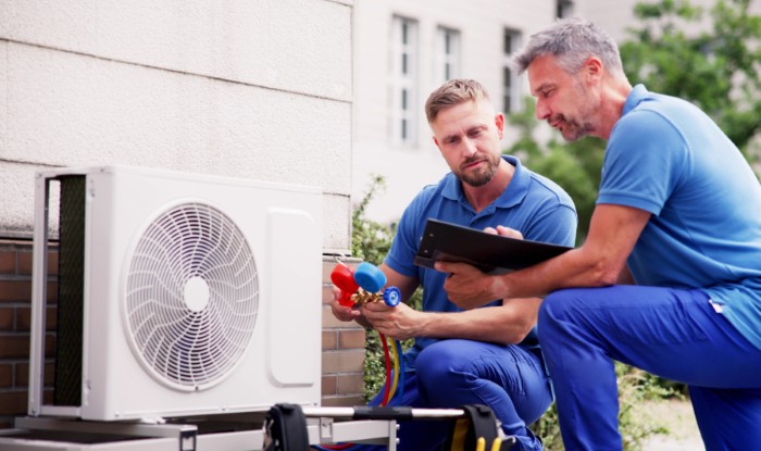 HVAC technicians installing an outdoor air conditioning unit in Moorpark