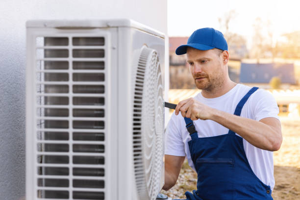 HVAC technician servicing an outdoor air conditioner in Moorpark