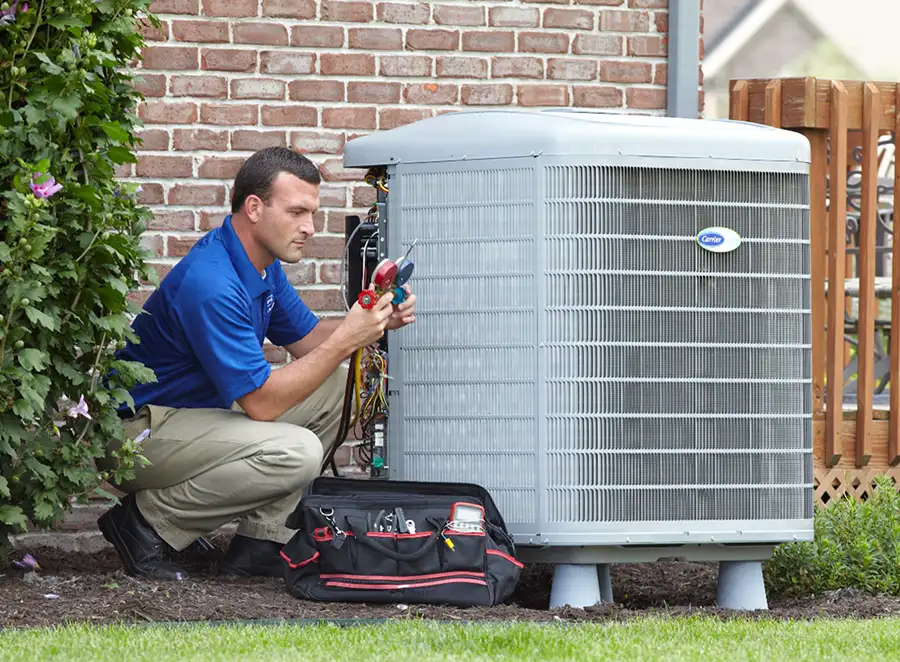 HVAC technician inspecting an outdoor AC unit in Moorpark