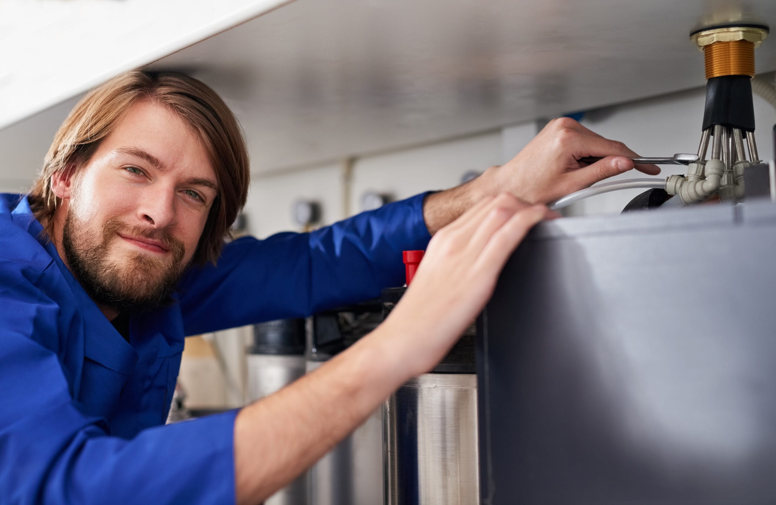 Technician servicing a residential water heater tank in Moorpark
